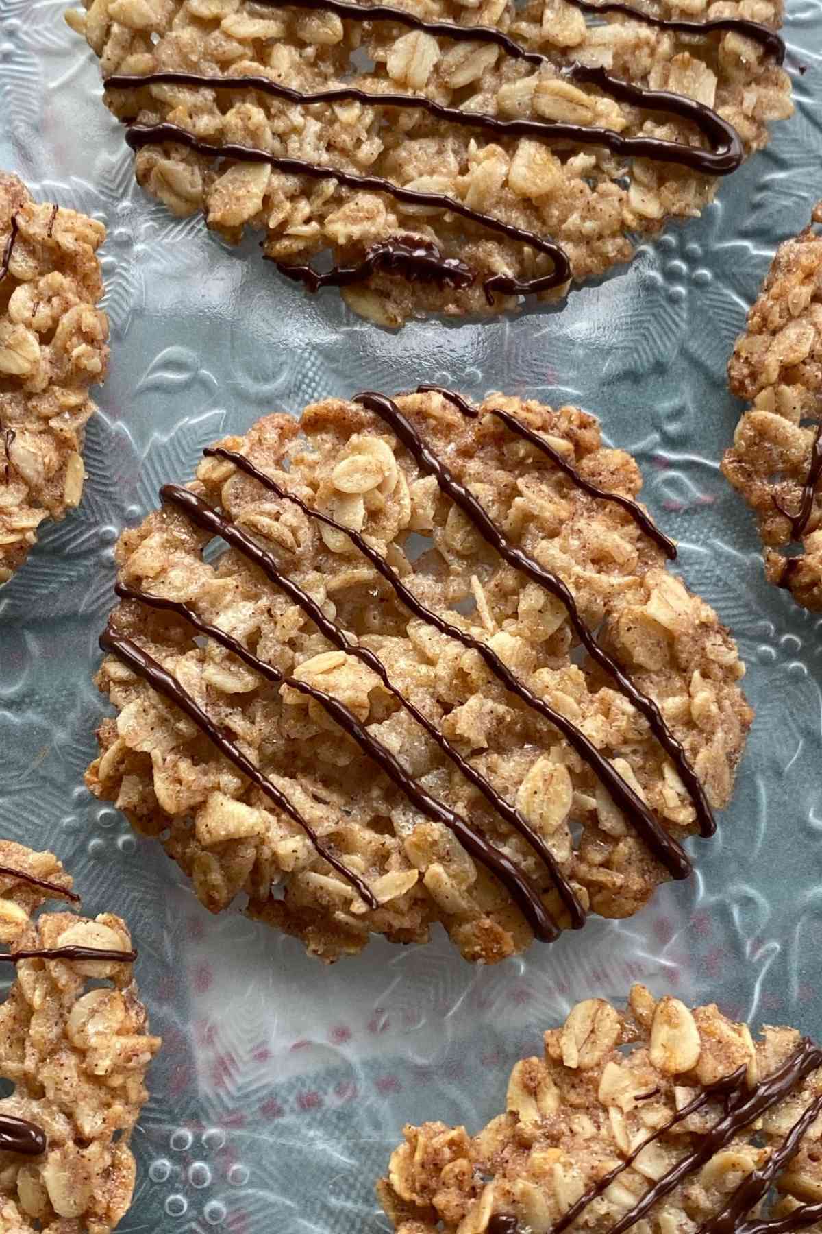 Vegan lace cookies drizzled with chocolate.