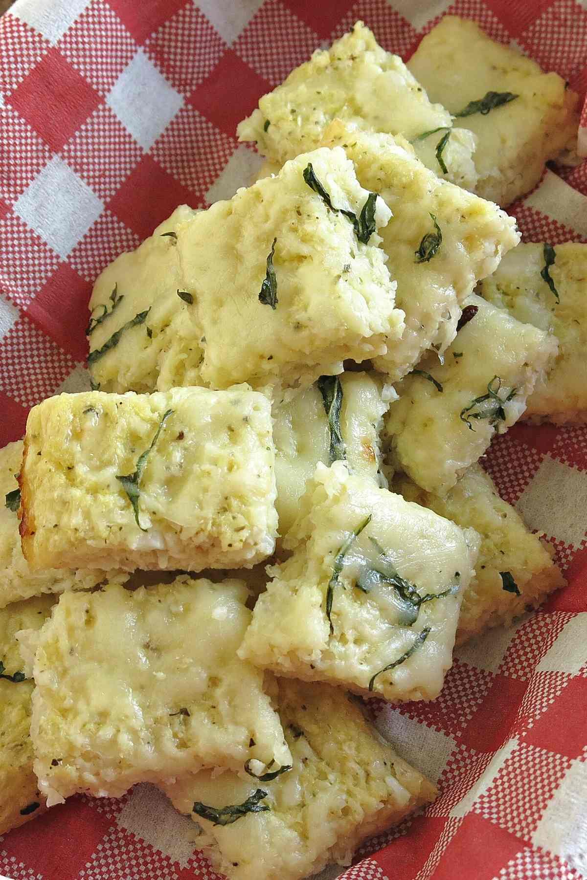 Cauliflower pizza bite appetizer in a serving basket.