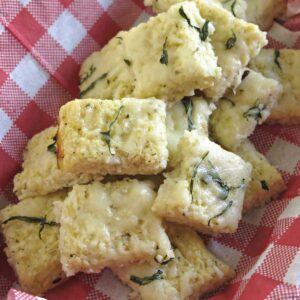 Cauliflower Pizza Bites in a basket lined with a red and white checkered napkin.