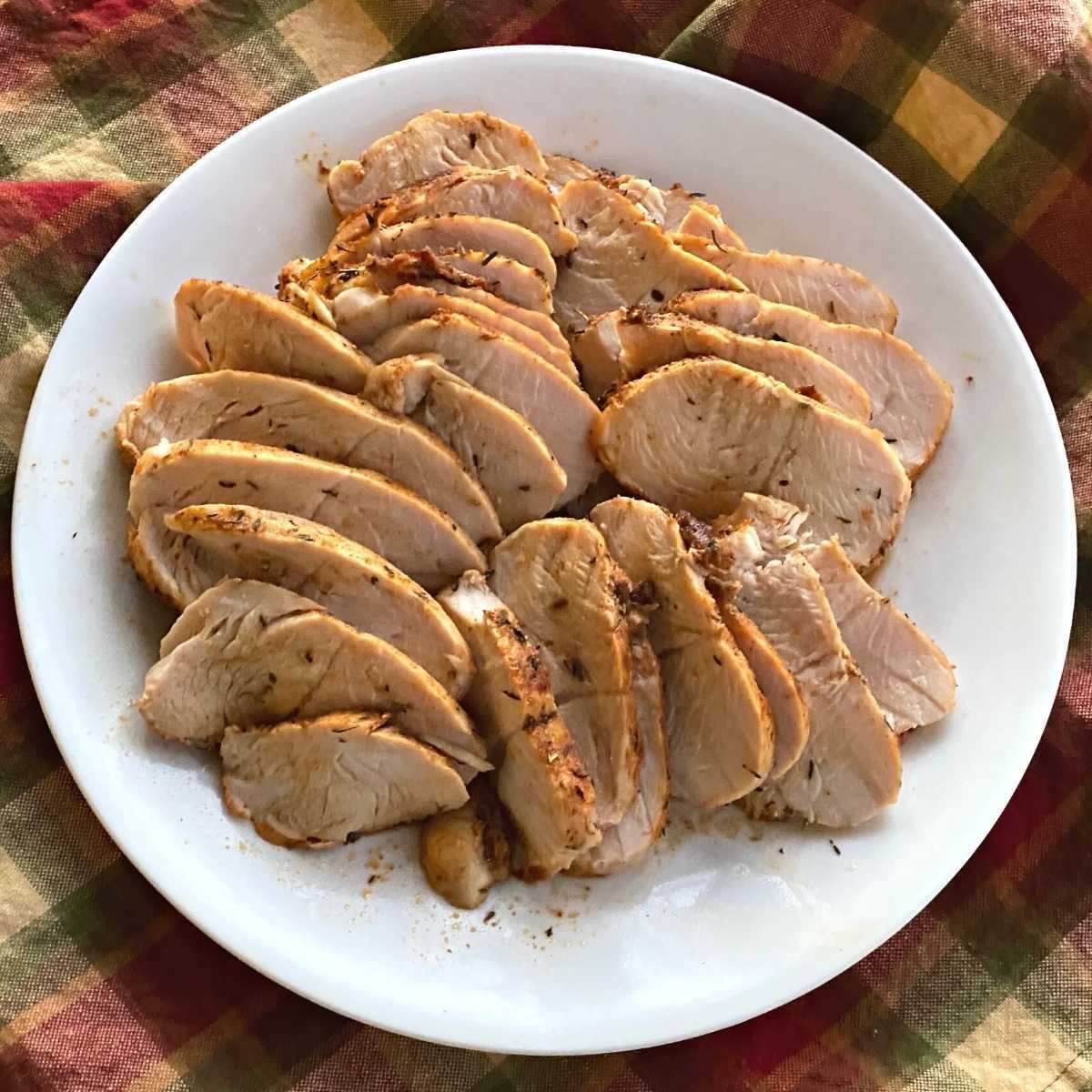 Sliced turkey breast tenderloin on a plate.