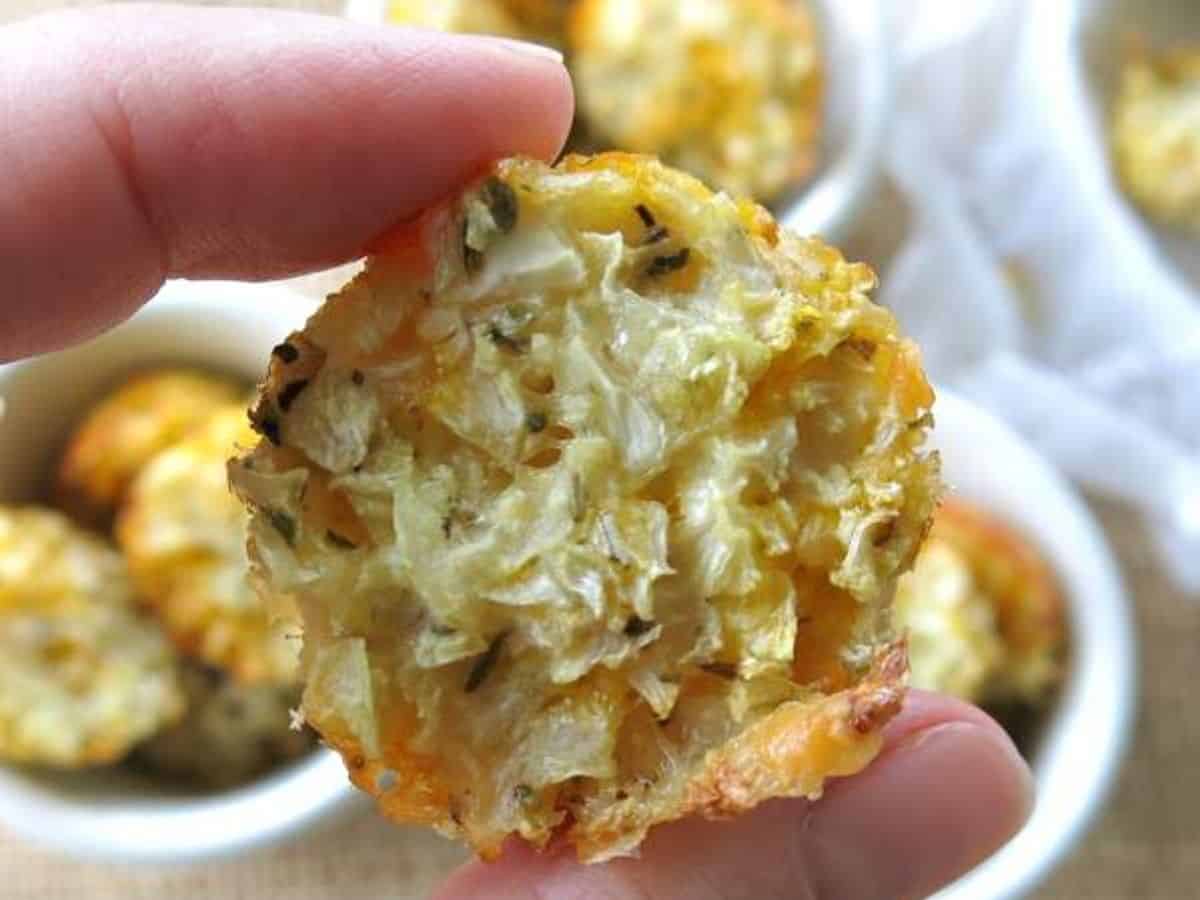 Fingers holding a low-carb cauliflower muffin.