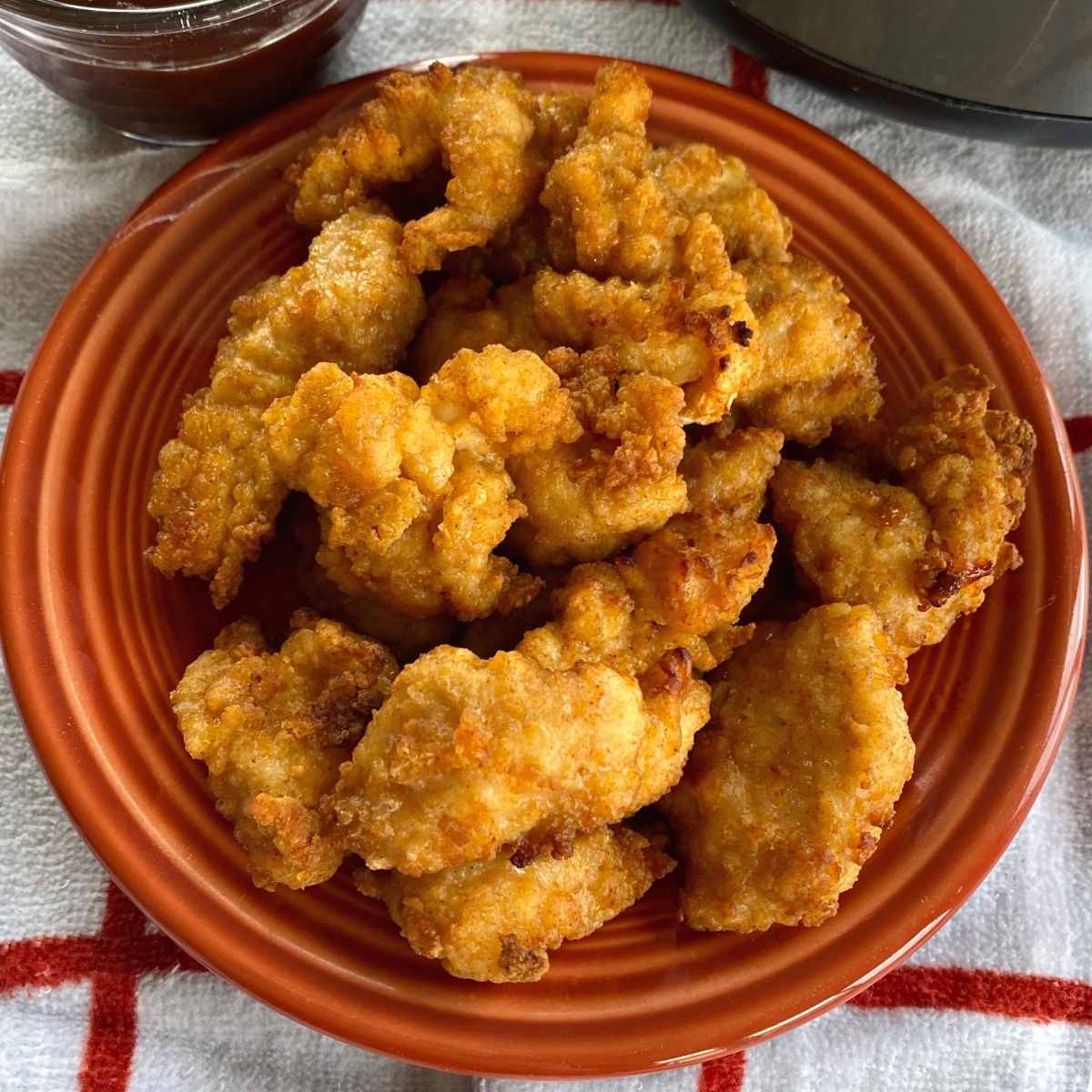 Plate of chicken nuggets cooked from frozen in an air fryer.