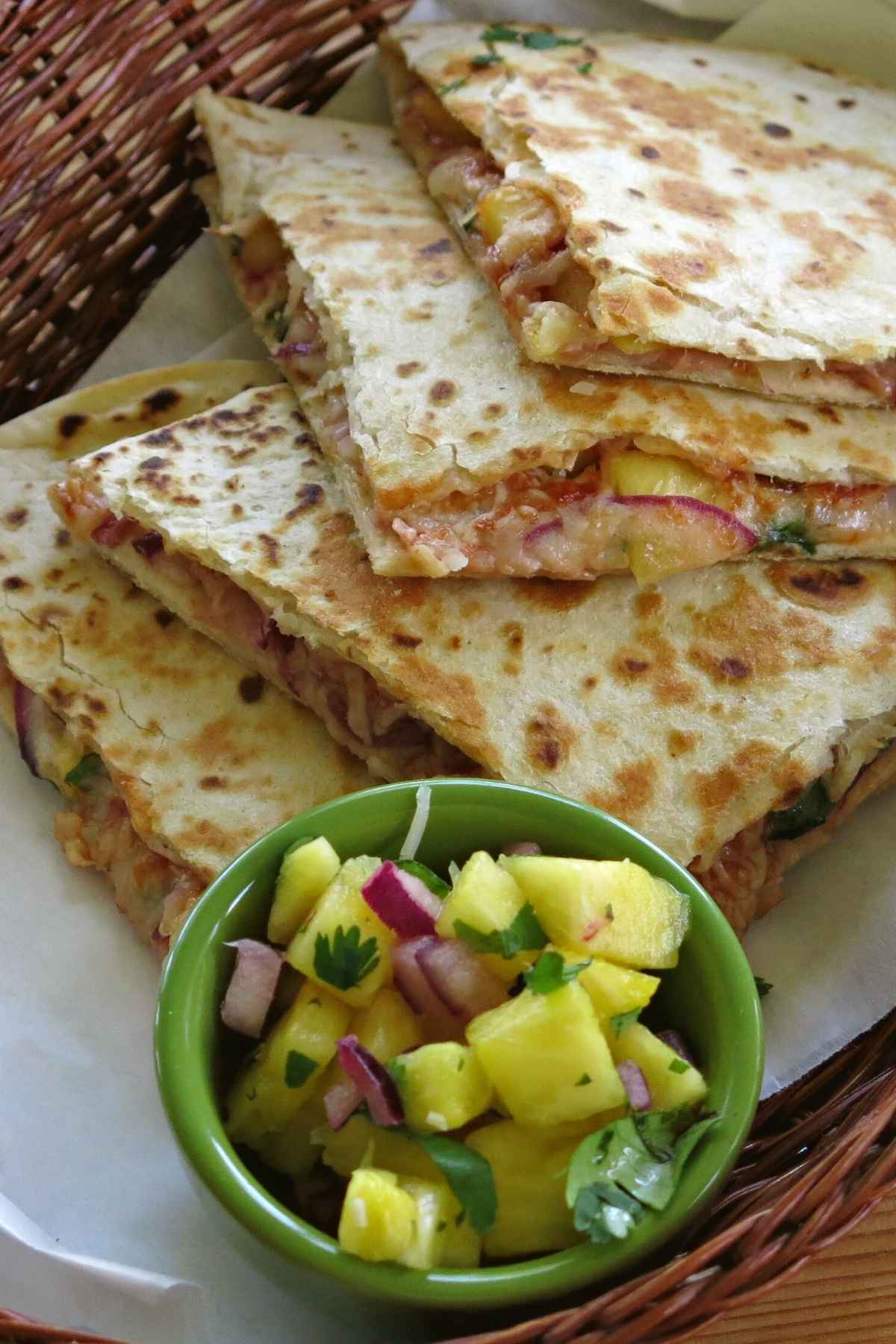 Basket with Hawaiian ham quesadillas and a pineapple salsa.