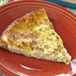 Make ahead crust quiche with ham and cheese on a plate.