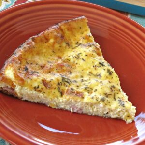 Make ahead crust quiche with ham and cheese on a plate.