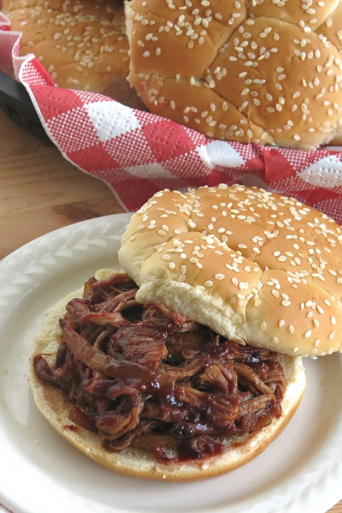 Crock-pot pulled pork tenderloin on a bun.