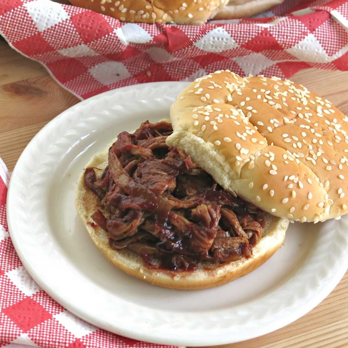 Slow cooker pulled pork tenderloin in a blackberry bbq sauce on a bun.