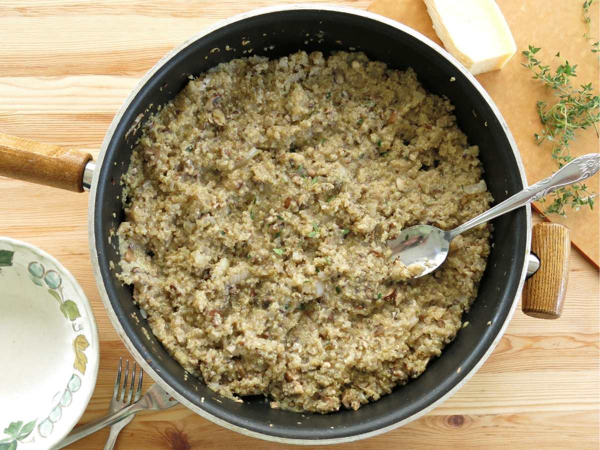 Creamy mushroom quinoa risotto in a large skillet.