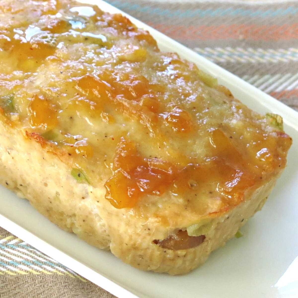 Ground turkey loaf topped with salsa on a platter.