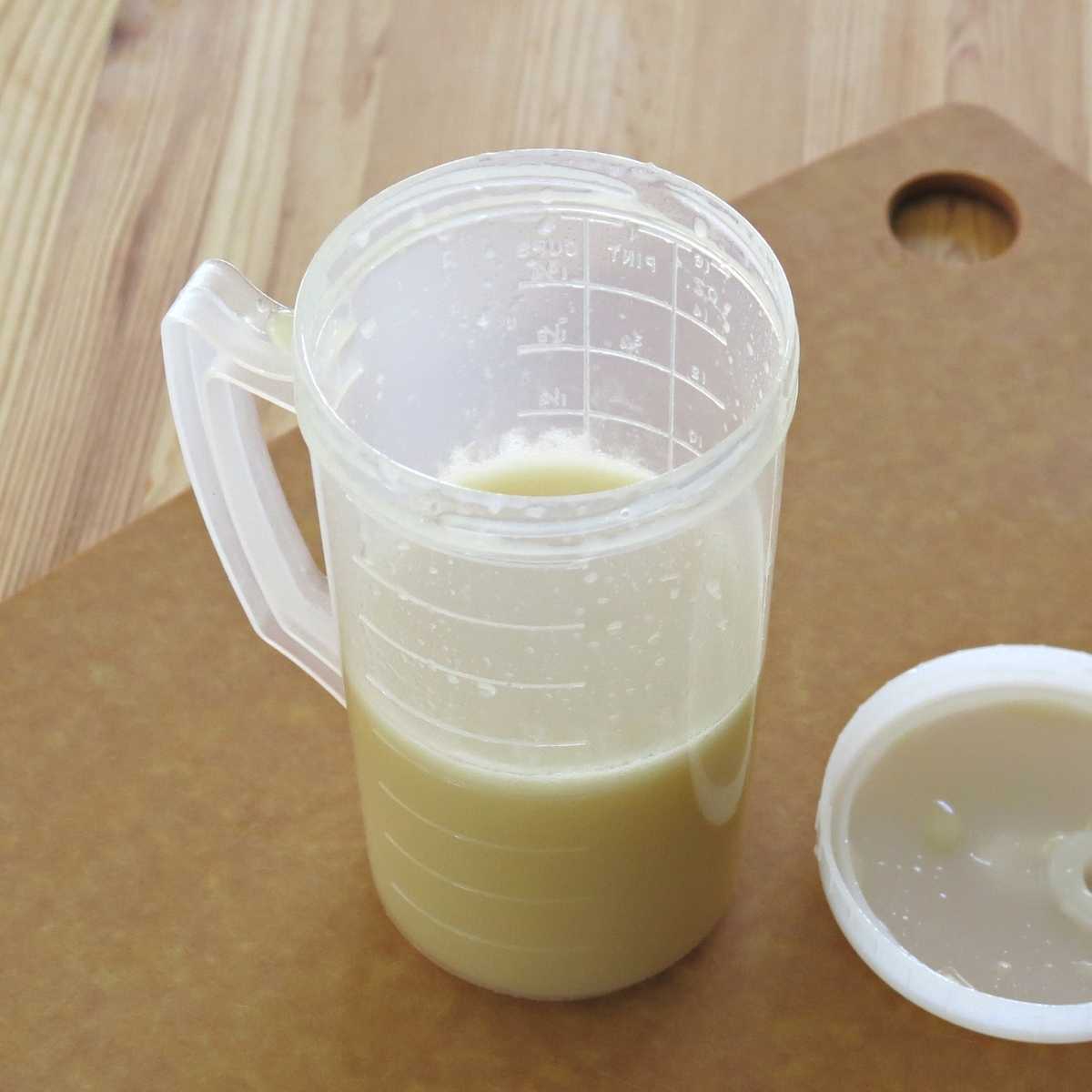 Honey lime dressing in mixing cup.