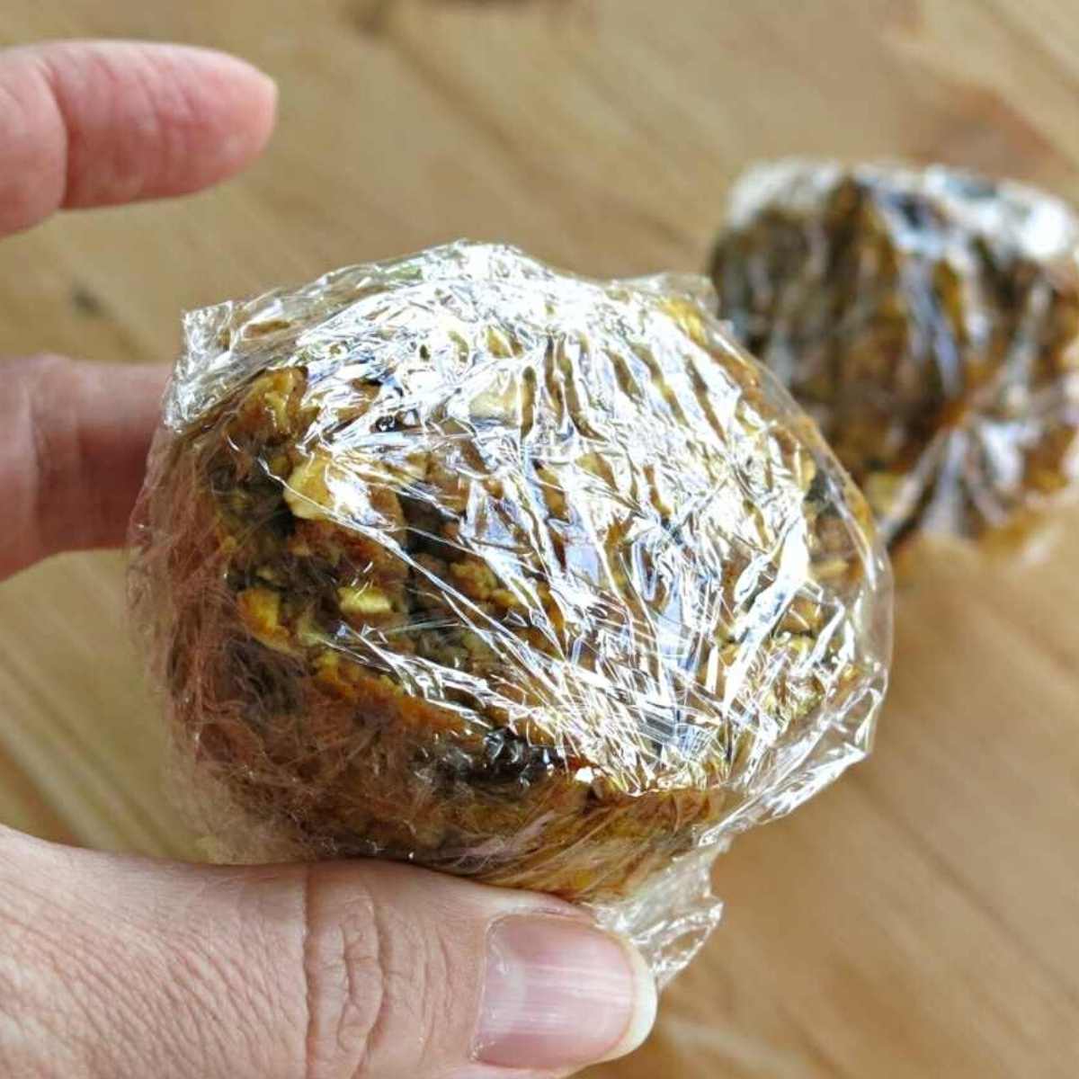 Oatmeal Pumpkin Muffin wrapped in plastic wrap.