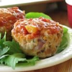 Healthy turkey meatloaf muffins with salsa, oats, and cheese on a plate.