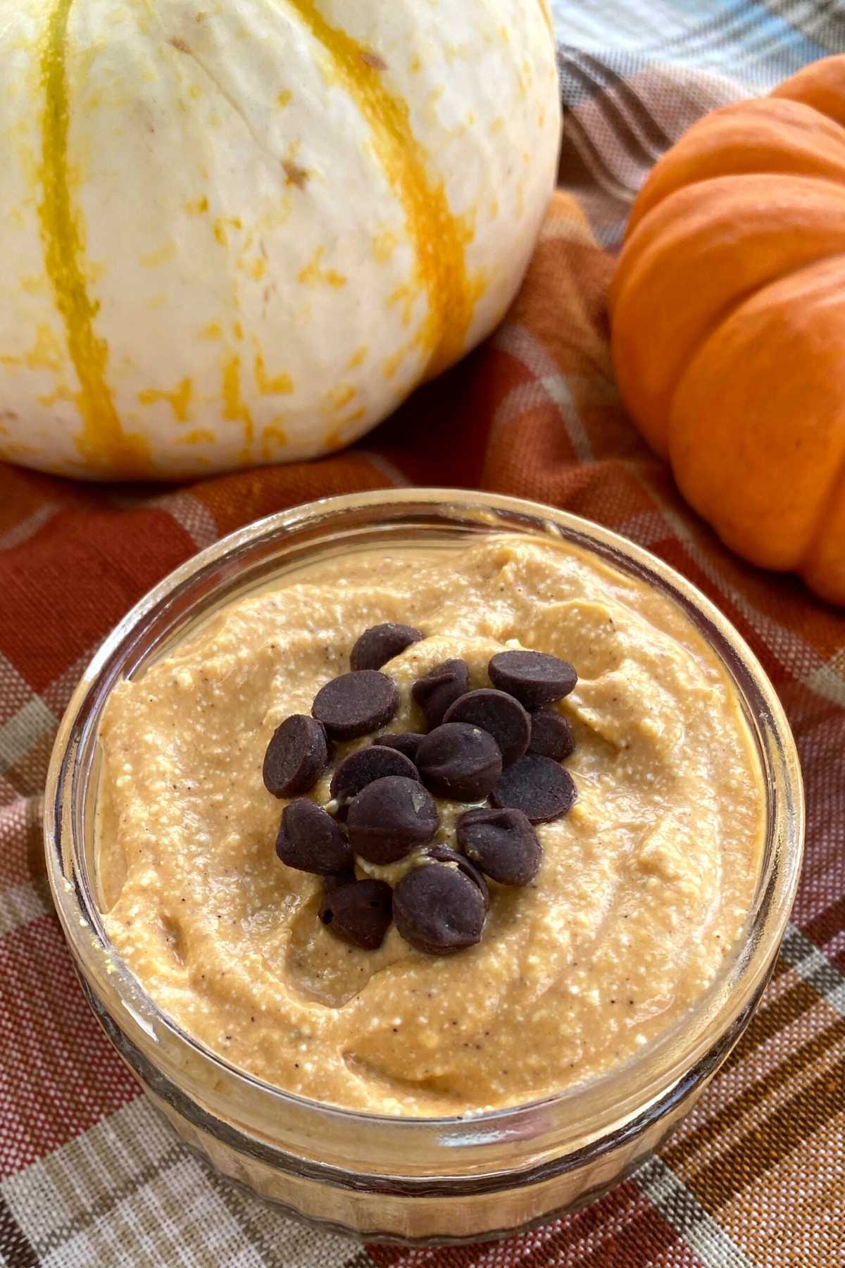 Whipped pumpkin cottage cheese dessert in a cup topped with chocolate chips. 