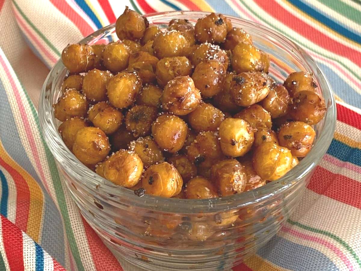 Sweet and spicy chickpeas in a glass serving dish.