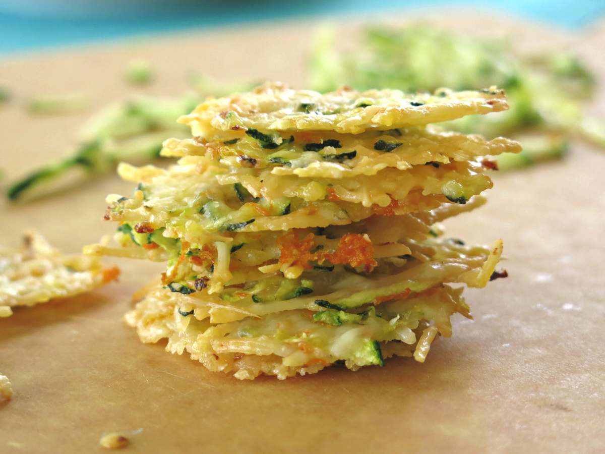Stack of eight Parmesan crisps with shredded zucchini and carrots. 