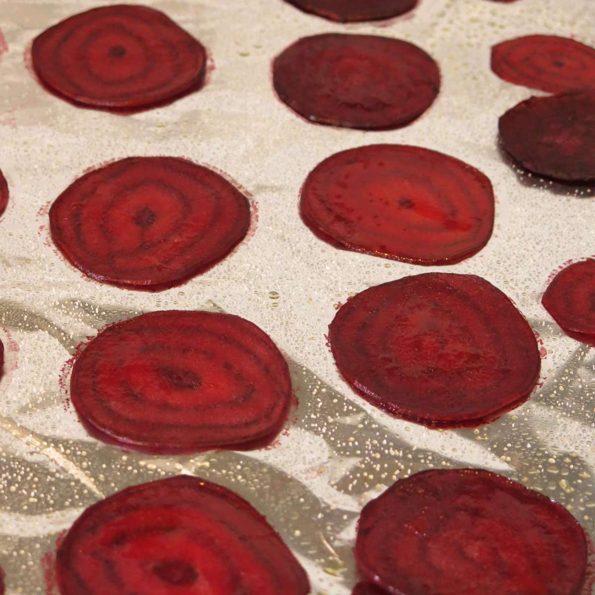 Slices of beets on a baking sheet.