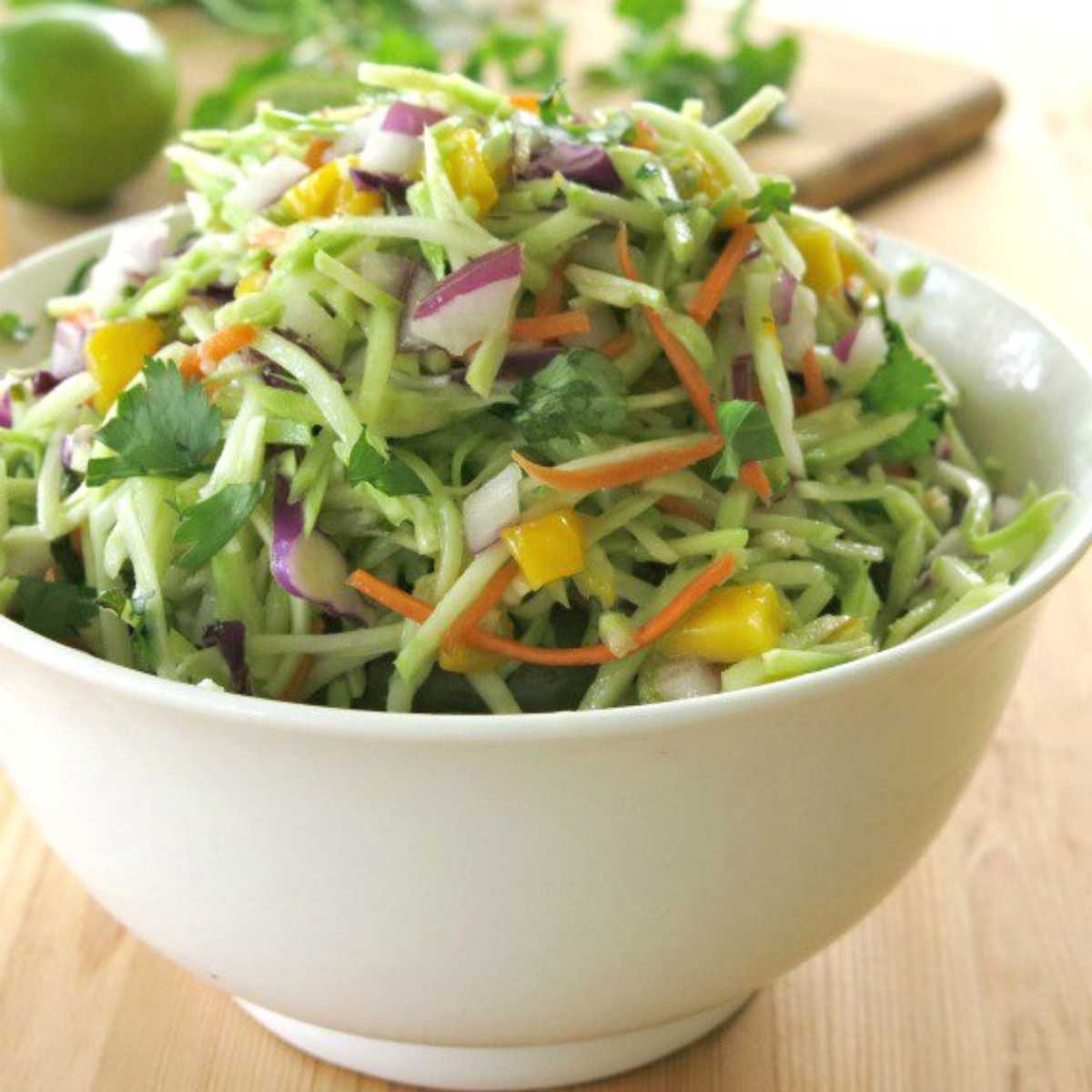 Broccoli slaw with honey lime dressing in a bowl.