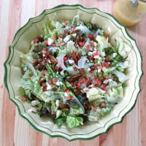 Summer fennel salad with shaved fennel, feta cheese, candied pecans, and watermelon in a large bowl.