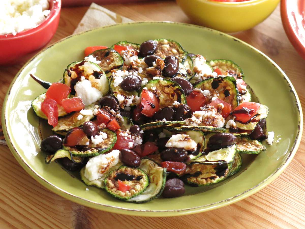 Low-carb zucchini chip nachos on a plate.