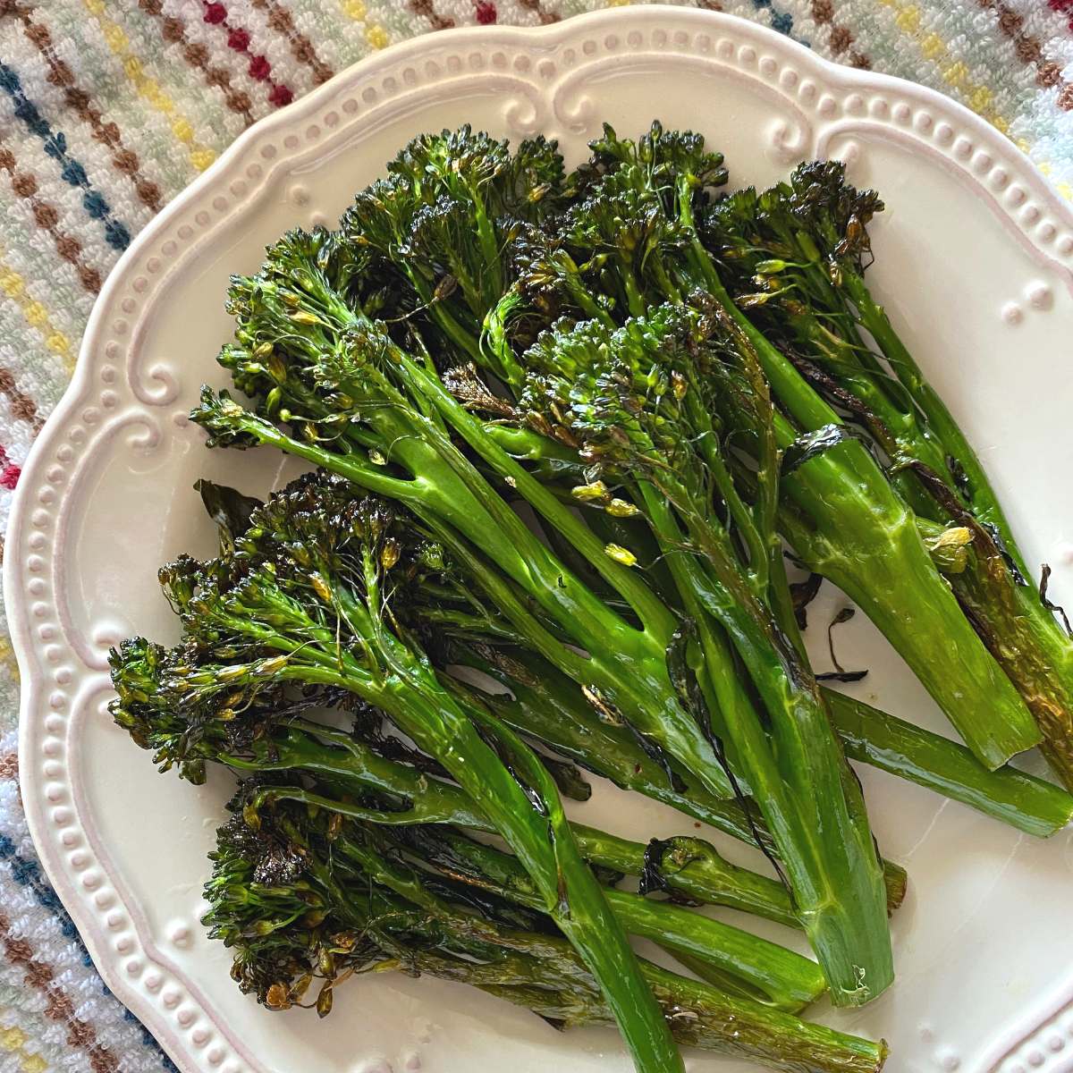 Roasted broccolini with lemon on a plate.