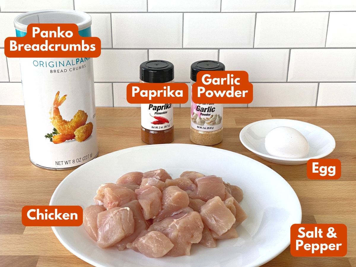 Ingredients to make chicken nuggets: chicken pieces, panko breadcrumbs, paprika, garlic powder, egg.