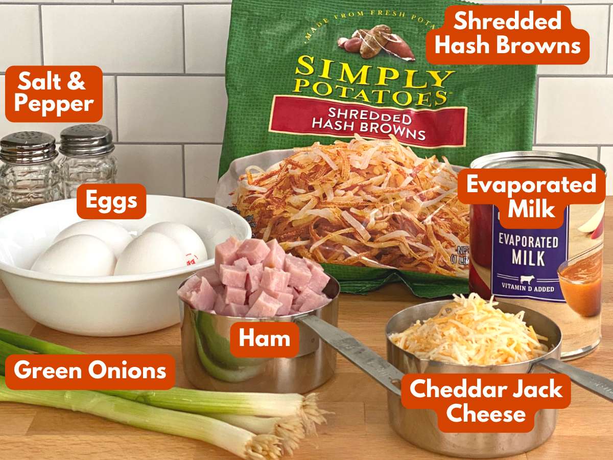 Ingredients to make Hash Brown Breakfast Casserole: Bag of Simply Potatoes has browns, eggs, evaporated milk, ham, cheese, green onions, salt, and pepper.