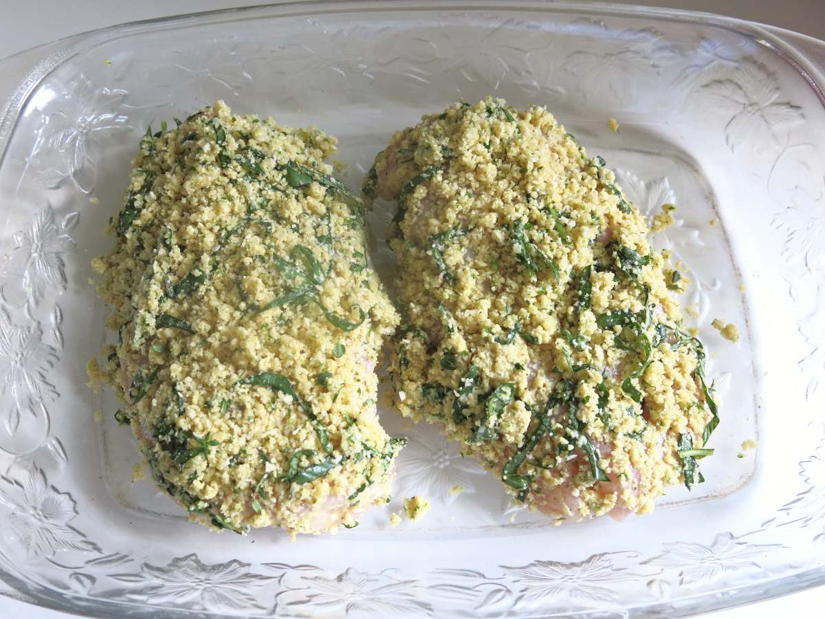 Uncooked Parmesan Herb Crusted Chicken breasts in a baking dish.