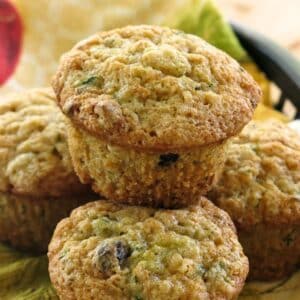 Healthy zucchini muffins made with yogurt and whole wheat flour stacked on top of each other.