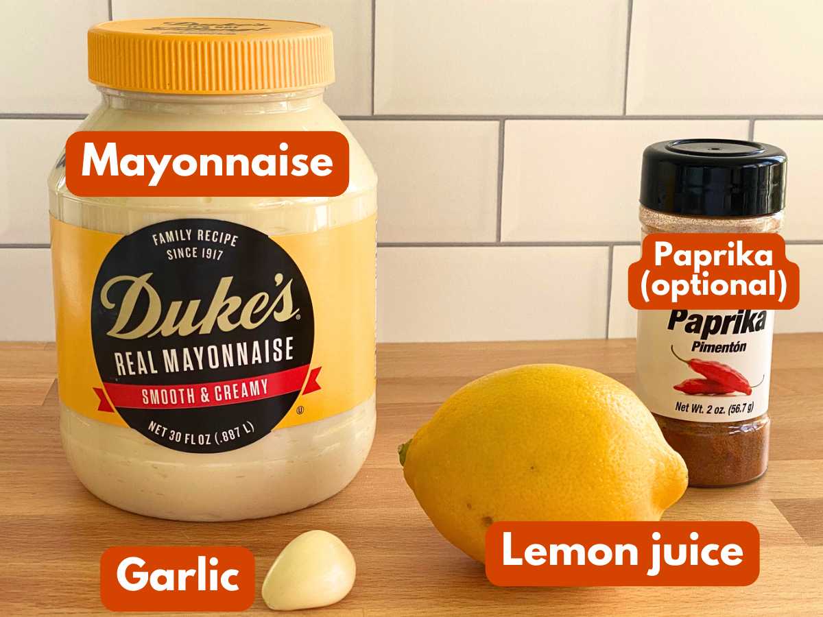 Ingredients to make lemon garlic aioli: Mayonnaise, garlic clove, lemon, and paprika (labelled as optional.)