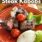 Steak Kabobs in Red Wine Marinade and vegetables off the skewer on a plate.