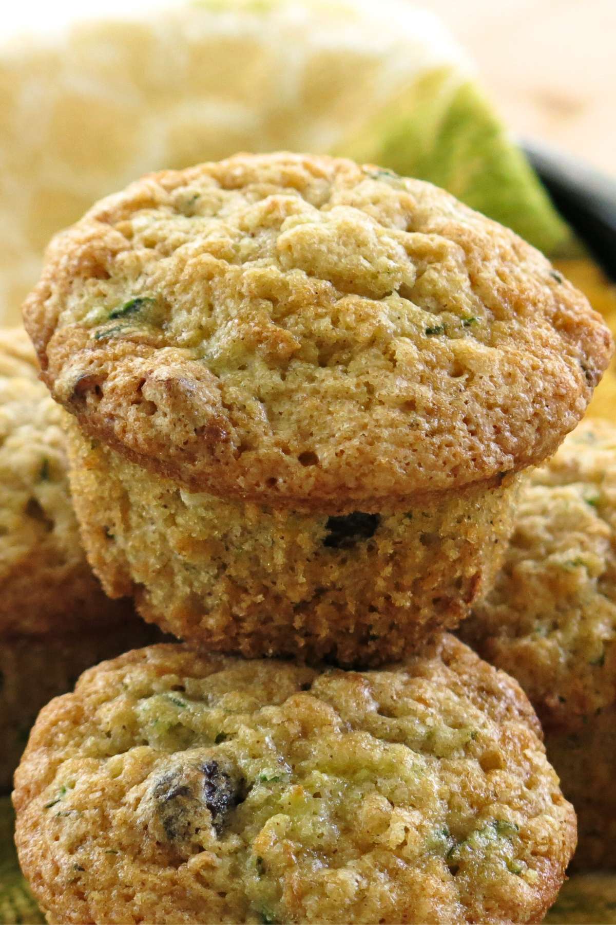 Two healthy zucchini muffins made with yogurt stacked on top of each other.