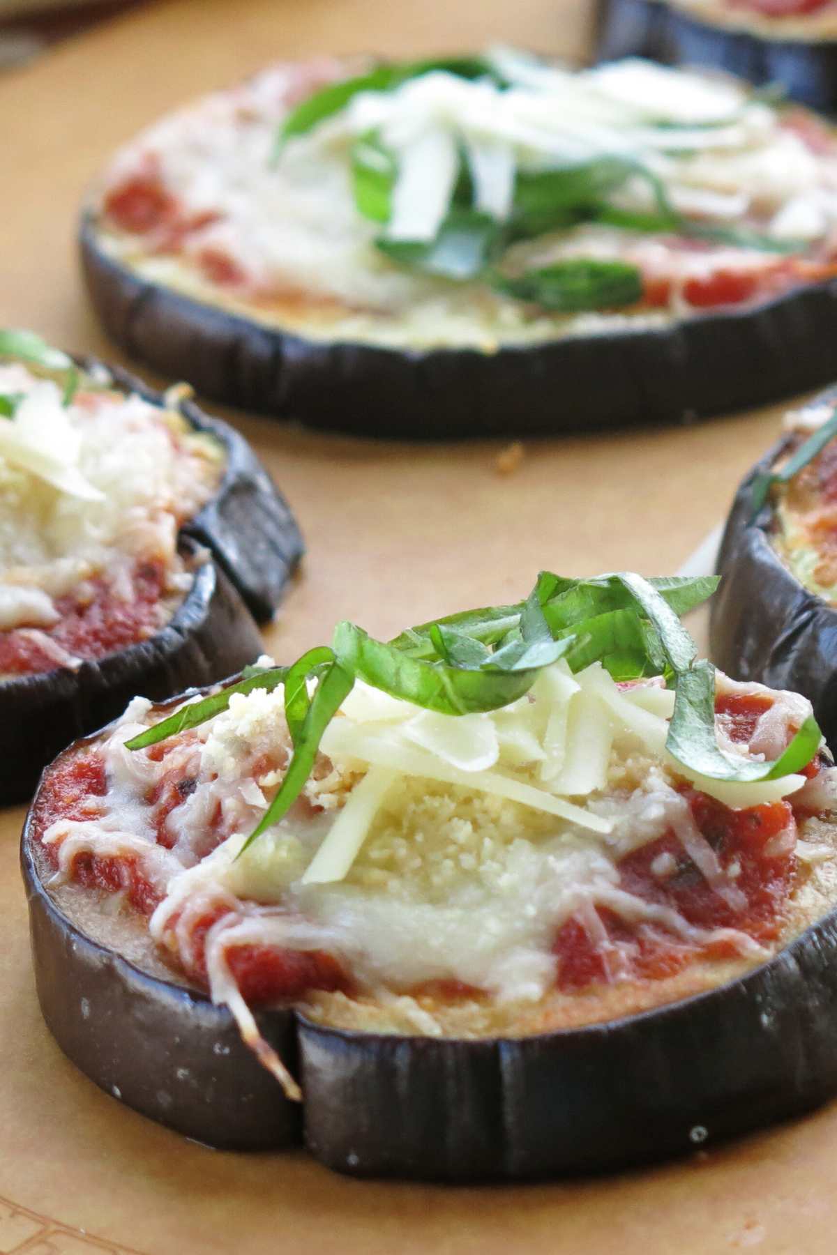 Sliced low-carb eggplant parmesan on a board.