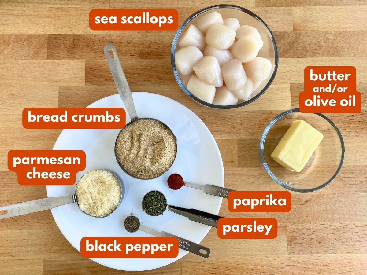 Labelled ingredients to make broiled scallops with Parmesan breading: sea scallops, butter, bread crumbs, parmesan cheese, paprika, parsley, black pepper.