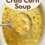 Ladle lifting creamy crab corn soup out of a serving bowl.