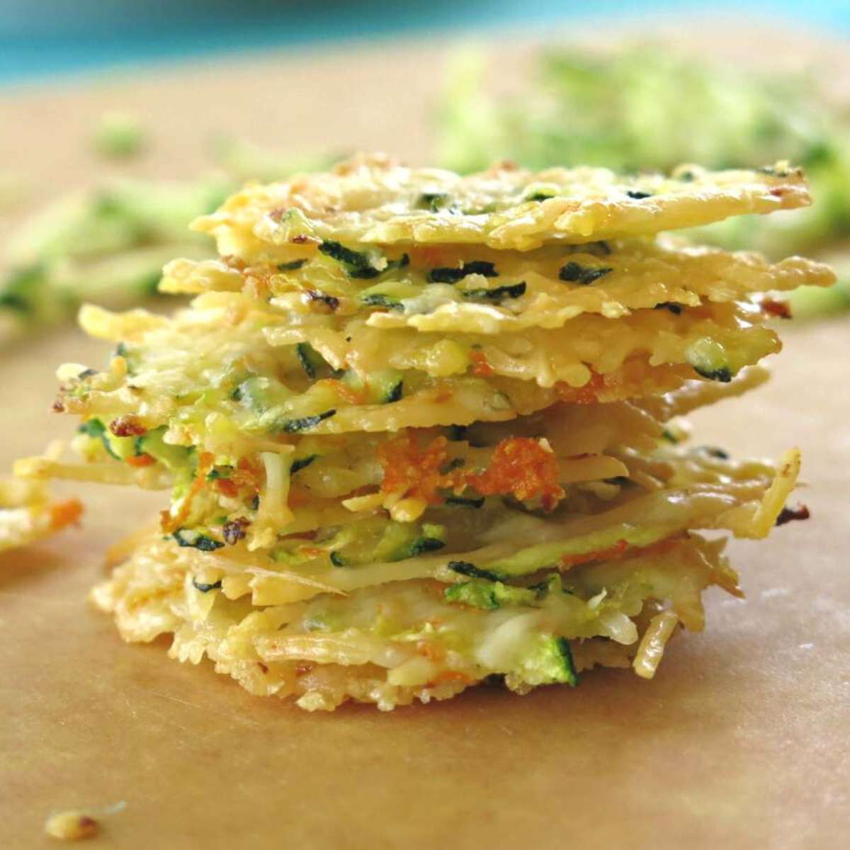 Seven Parmesan Cheese Crisps oven-baked with shredded zucchini and carrot stacked in a pile.