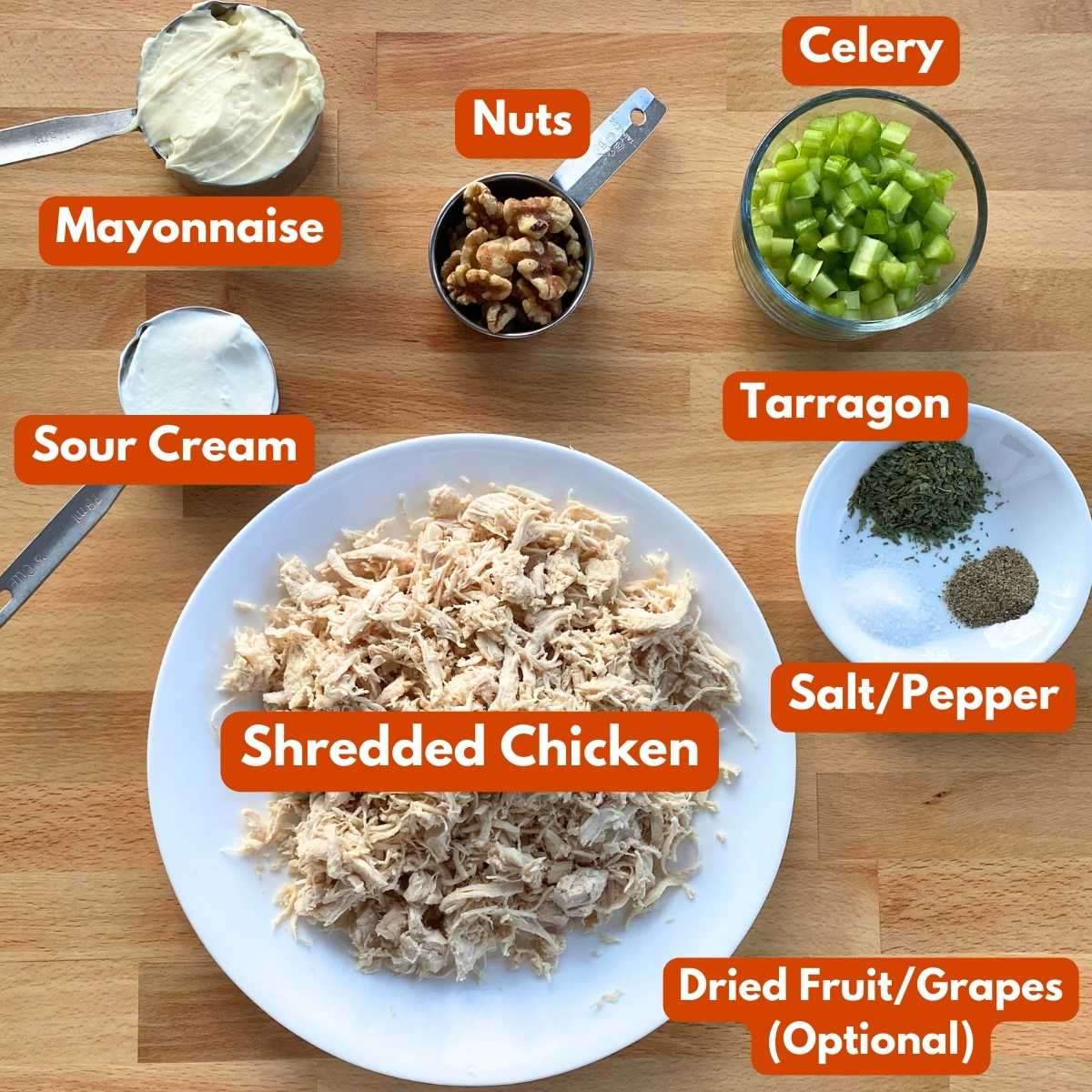 Labeled ingredients to make leftover chicken salad recipe: shredded chicken, mayonnaise, sour cream, walnuts, celery, tarragon, salt, pepper, dried cranberries