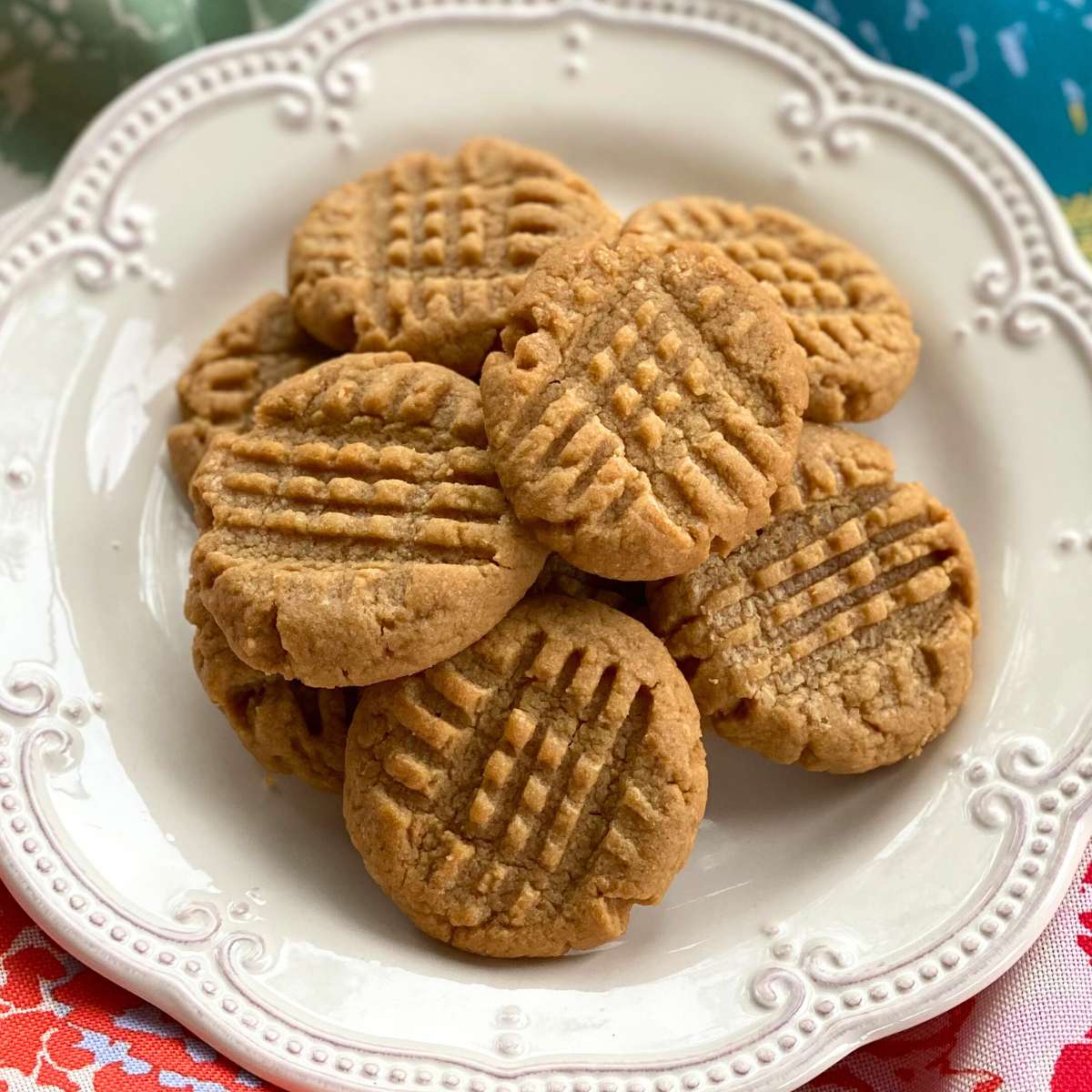 3-ingredient almond butter cookies on a cream plate.