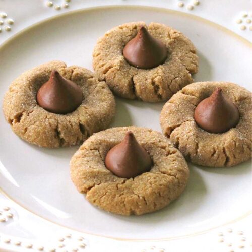 3-ingredient peanut butter blossom cookies on a plate, each topped with a Hershey Kiss.