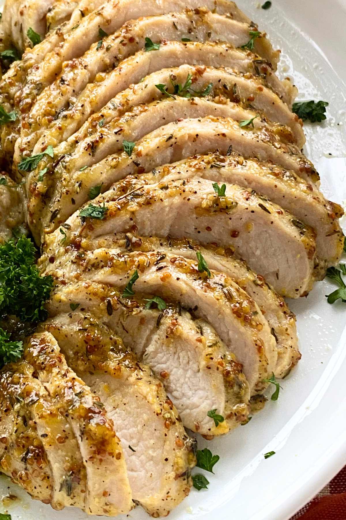 Platter of marinated sliced turkey breast tenderloin with maple dijon mustard garlic crust.