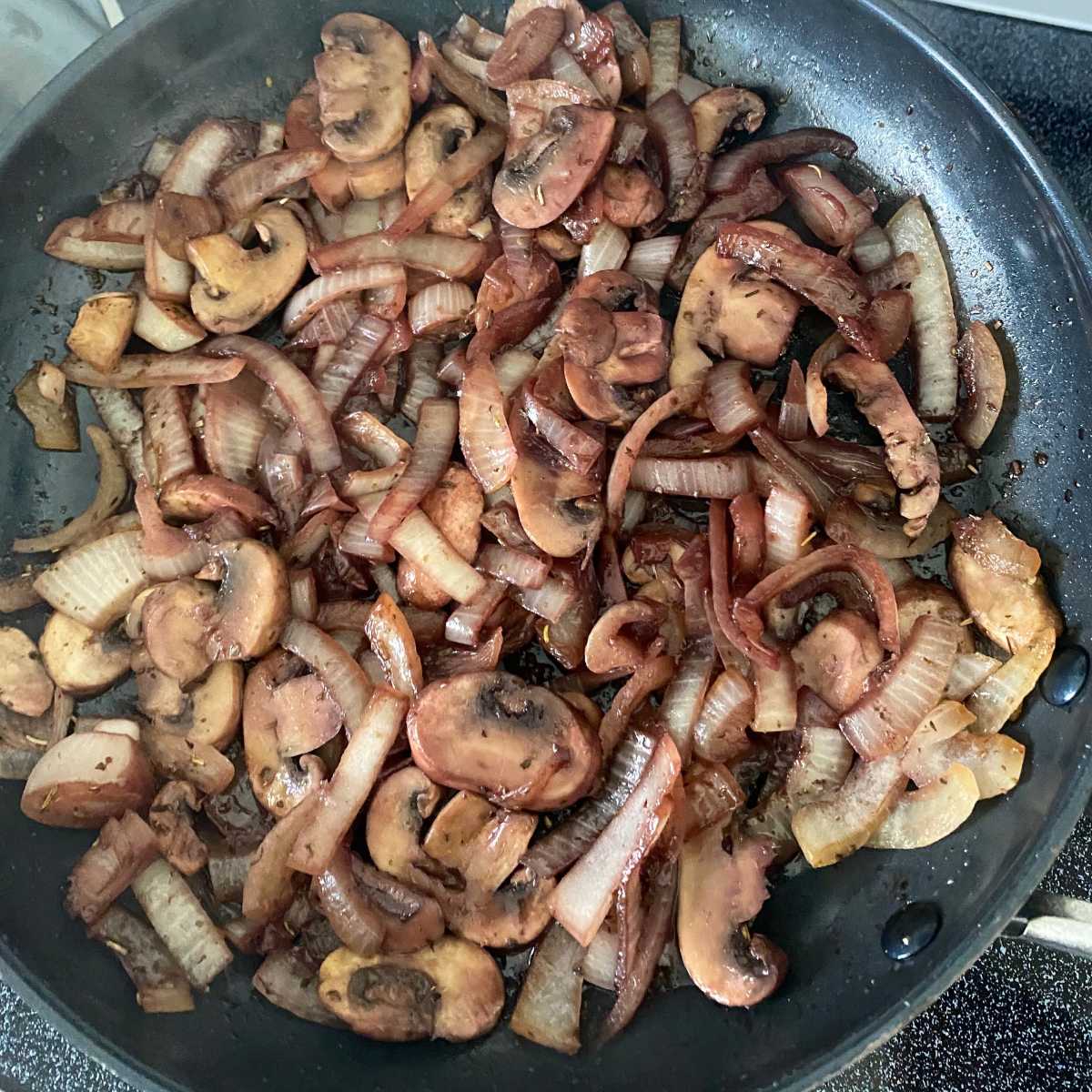 Mushrooms and onions after red wine was added and has mostly evaporated.