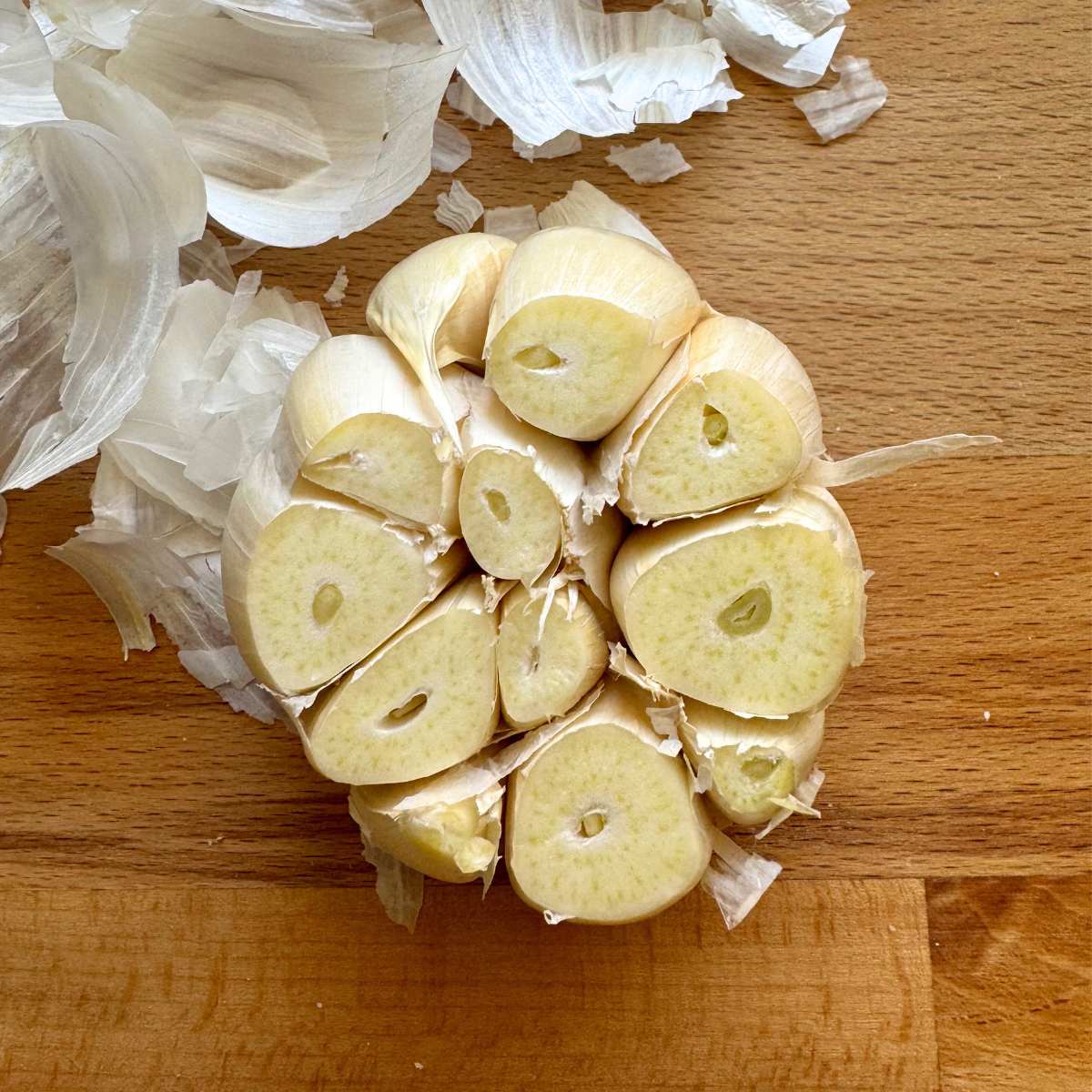 Head of garlic with papery skin removed and top cut off. 