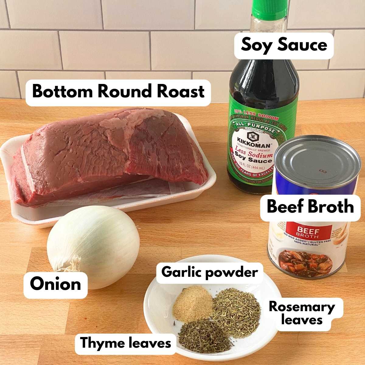 Ingredients to make bottom round in crock-pot: bottom roast roast, soy sauce, beef broth, onion, garlic powder, rosemary leaves, and thyme leves.