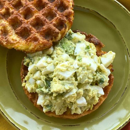 Healthy avocado egg salad made without mayo or yogurt on a chaffle.