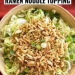 Napa cabbage salad with a crunchy ramen noodle and almond topping and Asian sesame dressing in a bowl.