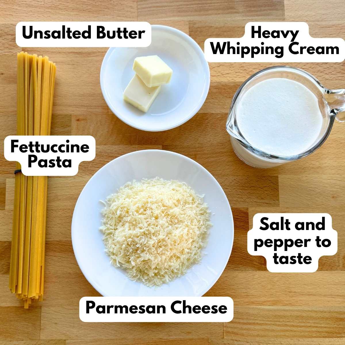 Labeled Ingredients to make fettuccine alfredo in one pot: fettuccine pasta, butter, heavy whipping cream, grated Parmesan cheese.