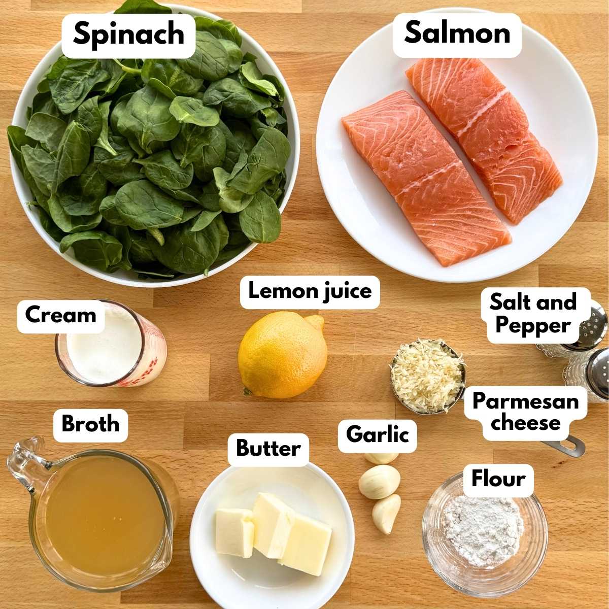 Labeled ingredients to make recipe: salmon, fresh spinach, cream, lemon juice, salt and pepper, Parmesan cheese, broth, butter, garlic, and flour.