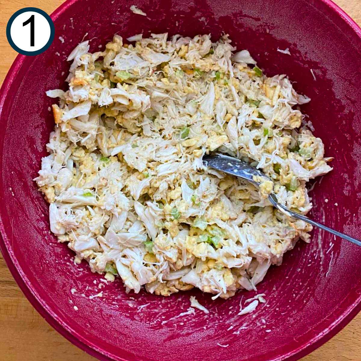 Mixed avocado crab cake mixture in a red bowl.