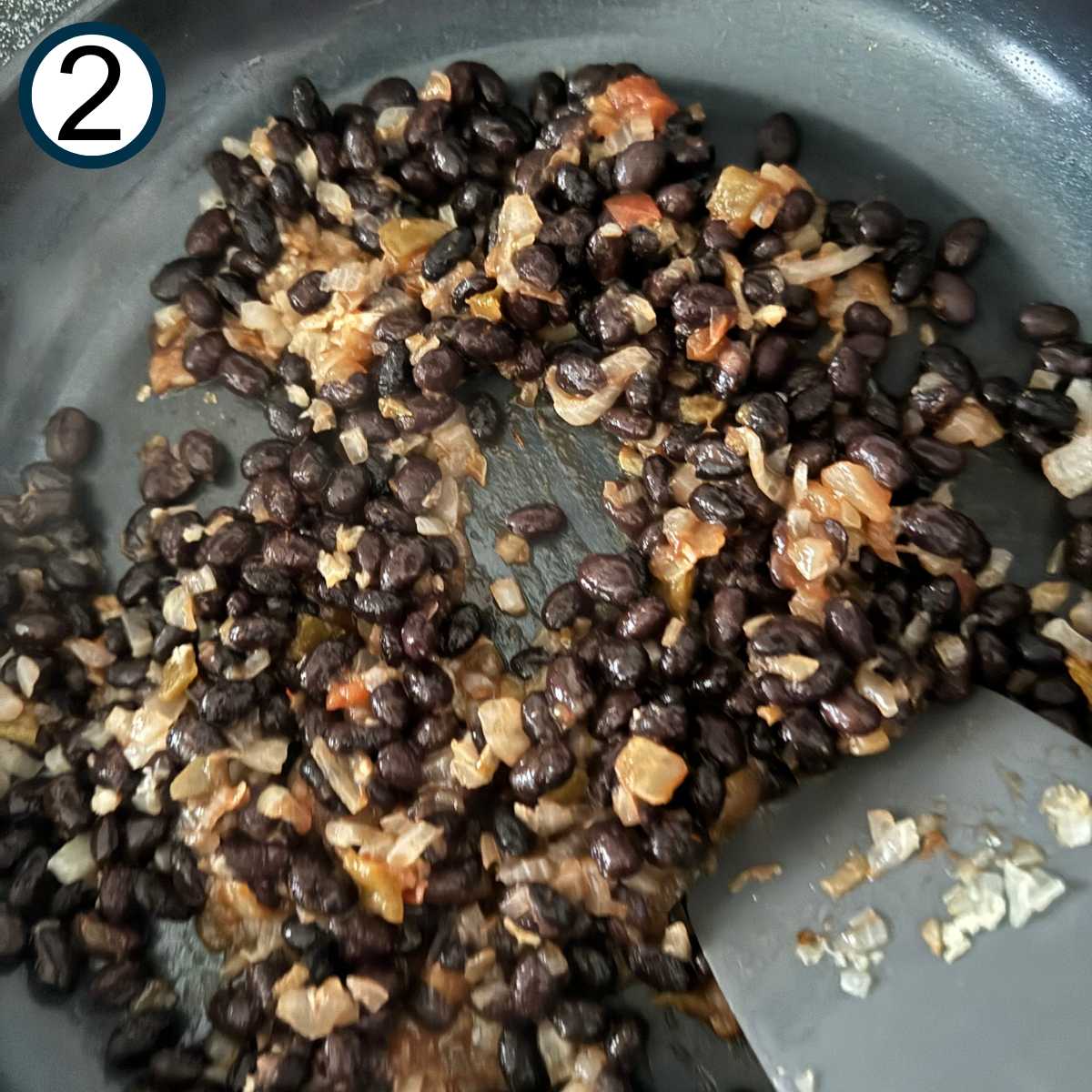 Black beans, onion, garlic, and salsa in skillet.