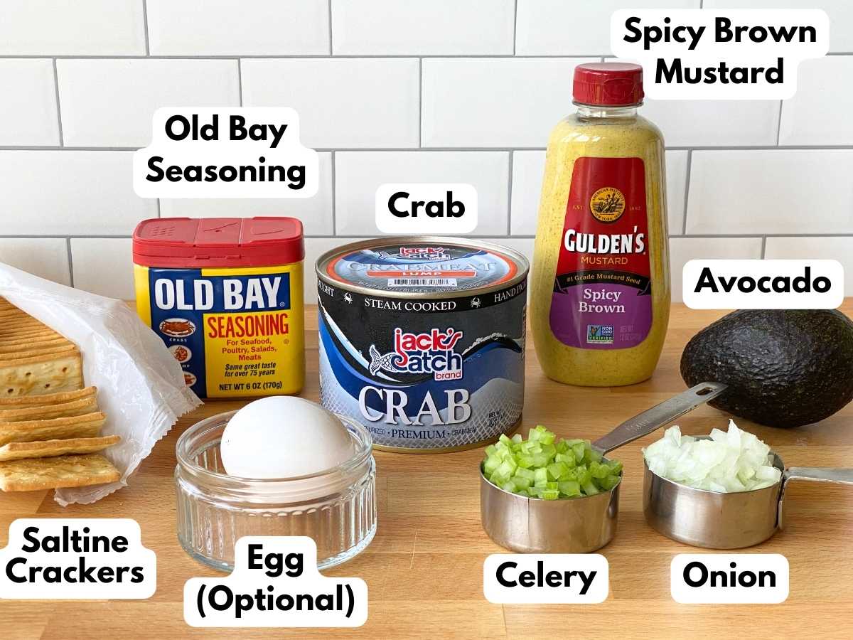 Ingredients to make avocado crab cakes: crab, Old Bay seasoning, spicy brown mustard, avocado, saltines, diced celery, diced onion.