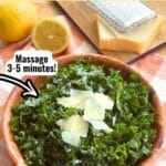 Massaged Kale Salad topped with shaved Parmesan cheese in a bowl with a lemon and block of Parmesan cheese behind it and with text overlay that says: Parmesan Kale Salad with lemon dressing and arrow pointing to leaves that says massage 3-5 minutes.